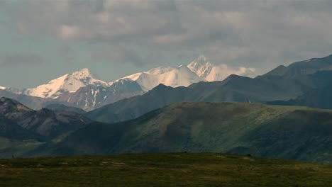 sunlit snowy mountains of denali national park range in alaska, north america