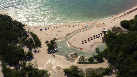 Tropical-Punta-Esmeralda-beach-with-vacationers-and-shimmering-sea