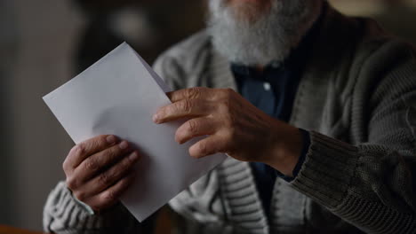 happy old gentleman receiving letter in cabinet