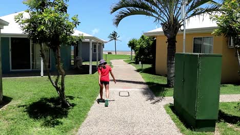 young girl walking funny in a tropical setting