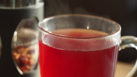 close-up of a steaming cup of red tea