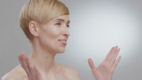 woman with short blonde hair expressing surprise