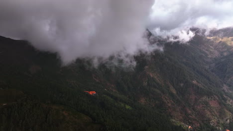 Aerial-view-around-low-hanging-clouds-covering-tall-mountains-of-Madeira