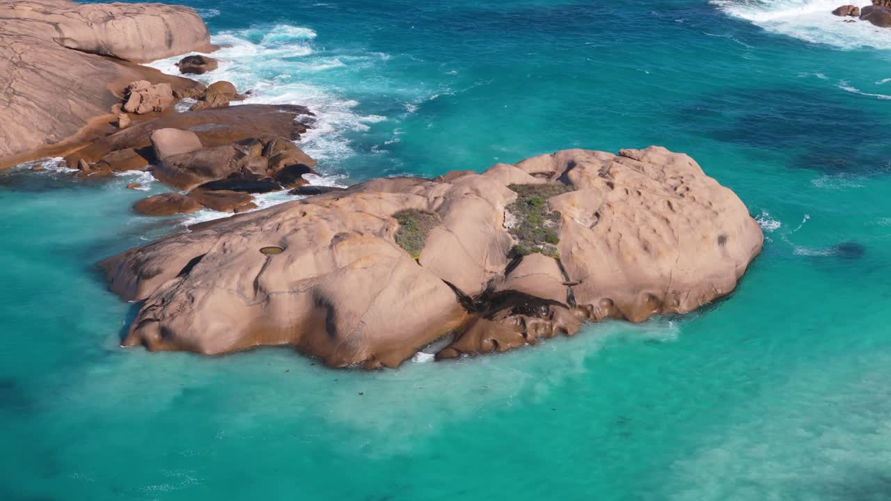 Flock of birds flying around jumping rock in Esperance, Western Australia