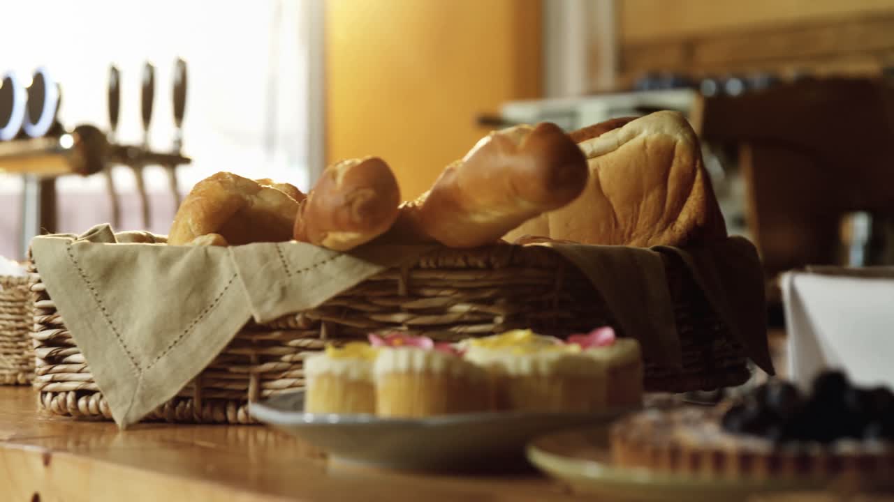 Loaf of bread and sweet foods at counter 4k