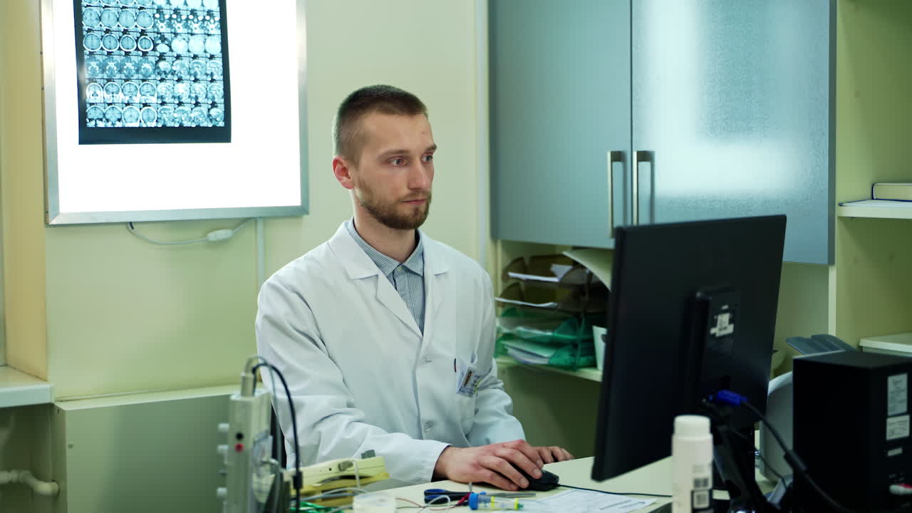 Scientists Working On Computer. Professional male doctor in a lab coat, typing on computer