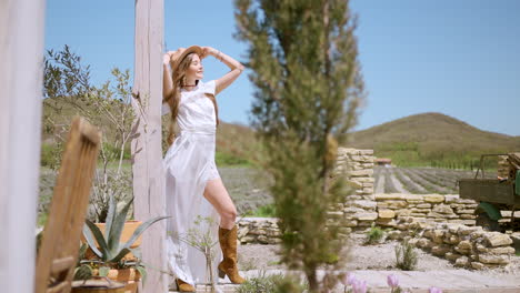 woman in a white dress and brown boots in a lavender field