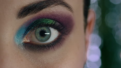 close up beautiful woman eye wearing colorful makeup cosmetics evening nightlife concept