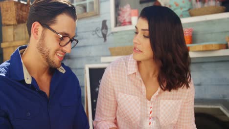 Couple-interacting-while-having-snacks-and-juice