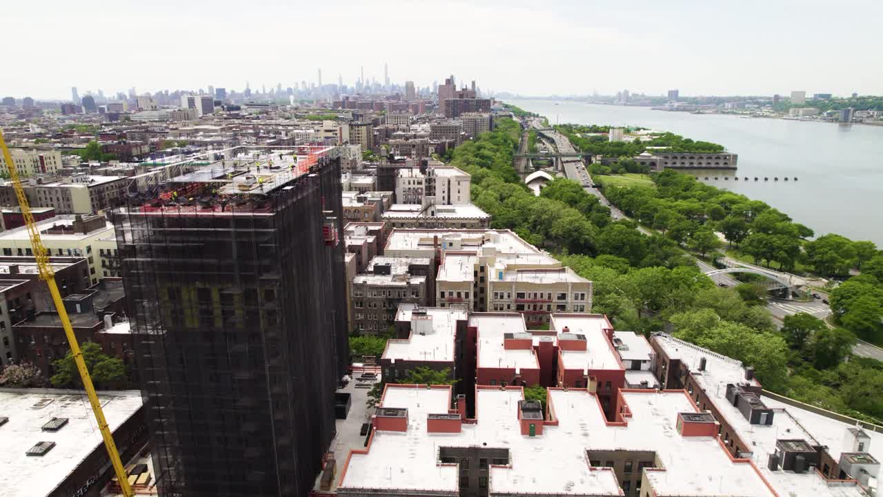 Harlem, NYC with new construction development. Parks and apartment buildings. Hudson River and traffic on the West Side highway.