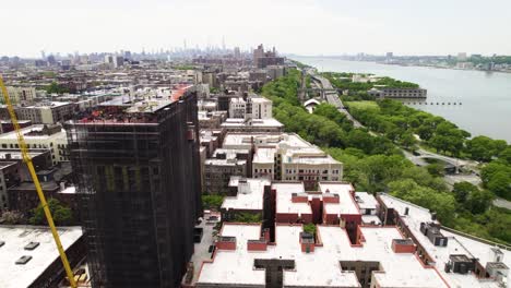 harlem, nyc with new construction development. parks and apartment buildings. hudson river and traffic on the west side highway.