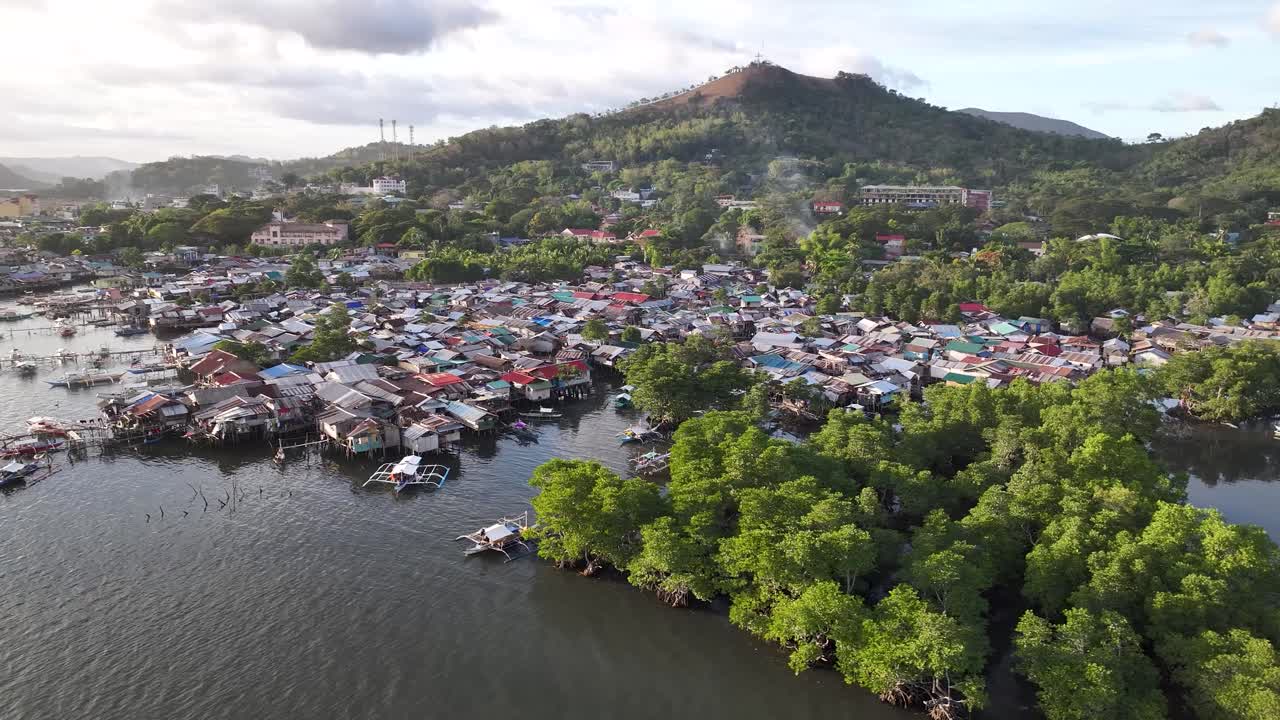 Aerial view of Coron poor district with slum on water with fishing boats. Philippines.