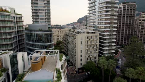 city high-rise skyscraper building rooftops in downtown monaco, aerial drone flight