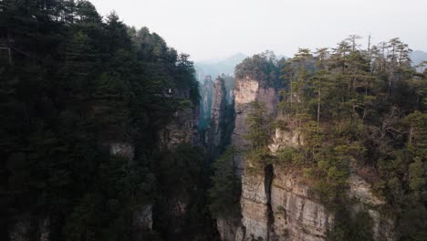 aerial view of towering sandstone pillars and dense forest in zhangjiajie national park under soft afternoon light