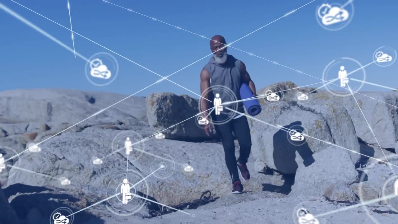 animación de una red de conexiones sobre un hombre afroamericano de edad avanzada con una alfombra de yoga en la playa