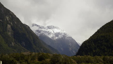 Timelapse-Snow-settles-at-sandfly-point-as-shadows-of-clouds-move-across-mountain