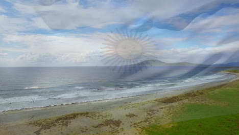 digital composition of waving argentina flag against aerial view of the beach