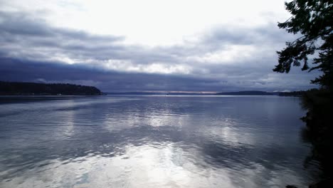 Slowly-flying-out-over-cold-dark-calm-waters,-Puget-Sound,-Washington,-aerial