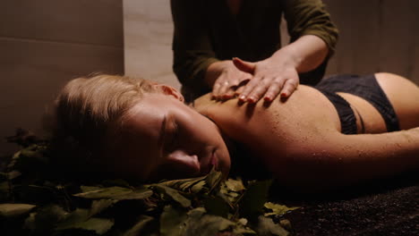 woman receiving a back massage in a spa or sauna