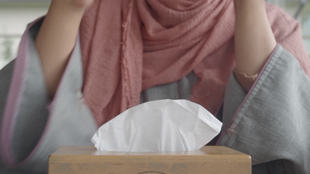 Person taking a tissue from a box