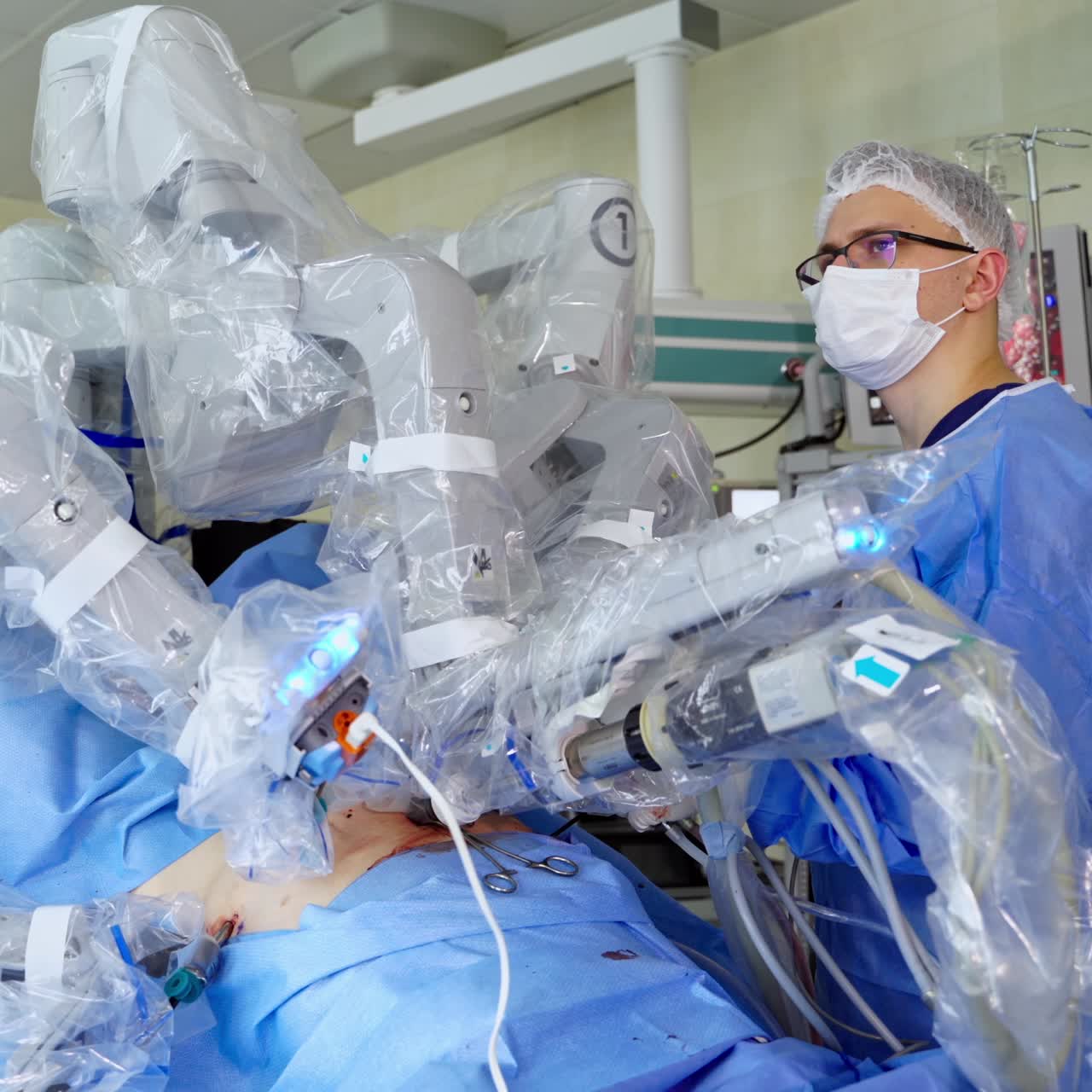 Surgical arms of a robot perform operation on a patient. Professional doctor perform surgery using robotic machine in clinic. Innovative medicine concept