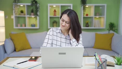 Eine-Müde-Junge-Frau,-Die-Im-Heimbüro-Arbeitet,-Hat-Nackenschmerzen.