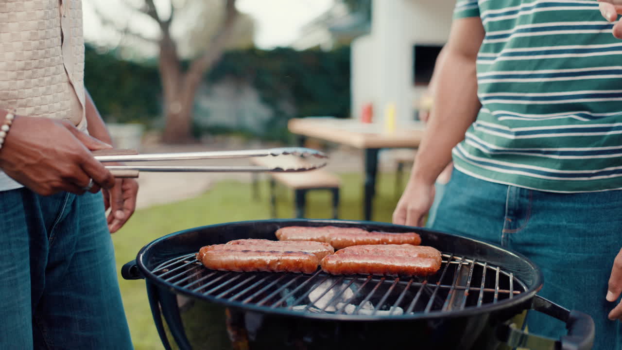 Grilling sausages at a backyard barbecue