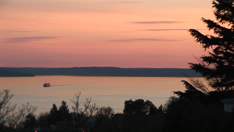 A-Vivid-Sky-During-The-Goldenhour-Lights-Up-A-Golden-Pond-As-A-Boat-Moves-Slowly-Across-The-Surface-Of-The-Water