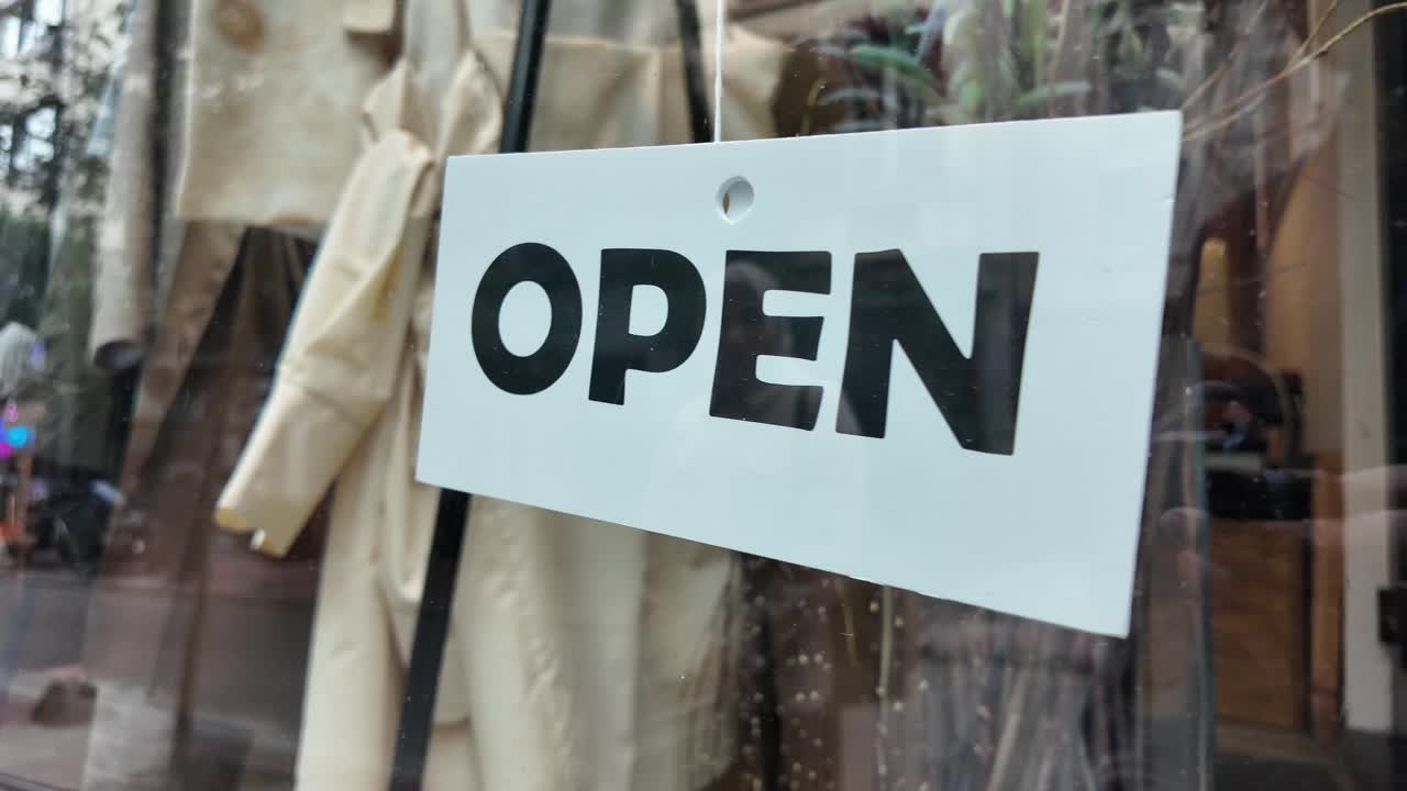 An 'Open' sign in a storefront window