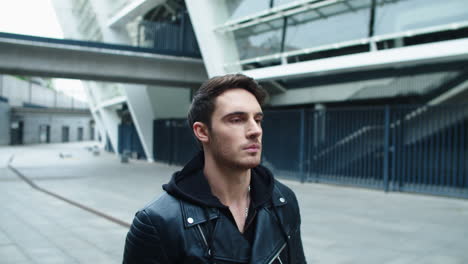 Focused-male-model-walking-on-street