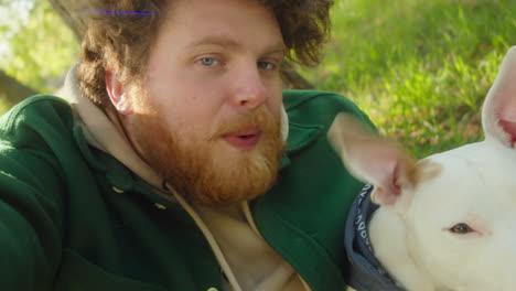 pov of smiling man taking selfie with dog