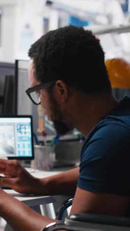 Vertical Video African american wheelchair user testing CAD software for manufacturing