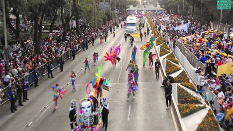 people performing a mexican traditional folk dance during the day of the dead parade on the streets of mexico city