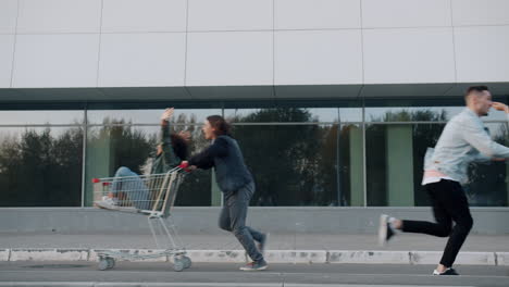 friends riding shopping carts