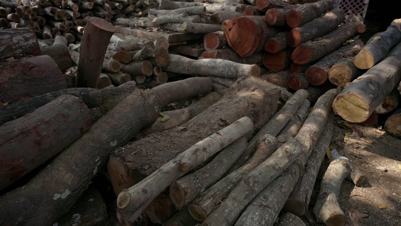 A detailed closeup of stacked timber and raw wood logs on a sunny summer street, perfect for forestry or construction industry content