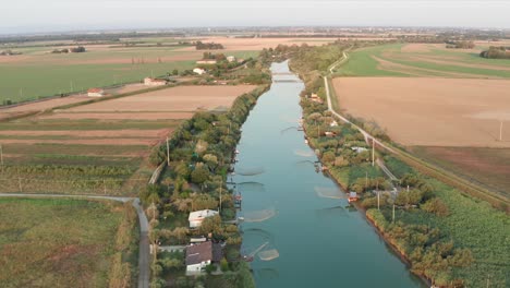 panorama of fishing huts with typical italian fishing machine, called ""trabucco"",lido di dante, fiumi uniti ravenna near comacchio valley