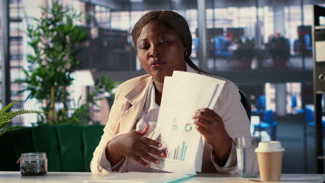 businesswoman reviewing documents in a library