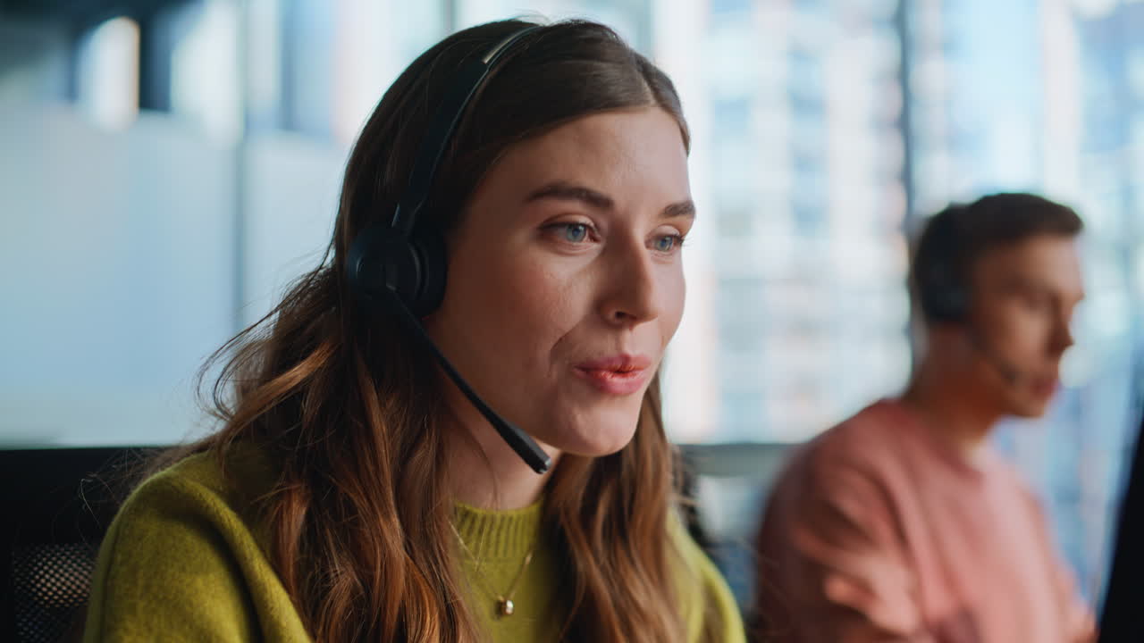 Consultant hands entering data keyboard talking with client by headset closeup