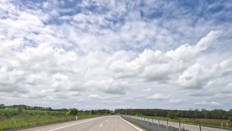 a journey on a highway with trucks and changing skies