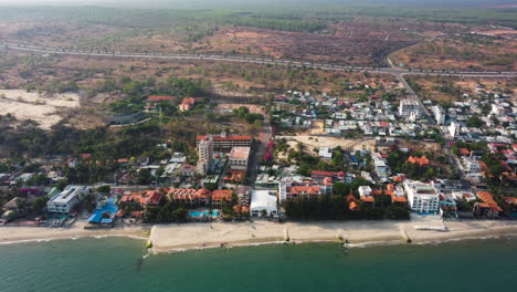 aerial panning view of ham tien with rising sea level and coastal erosion