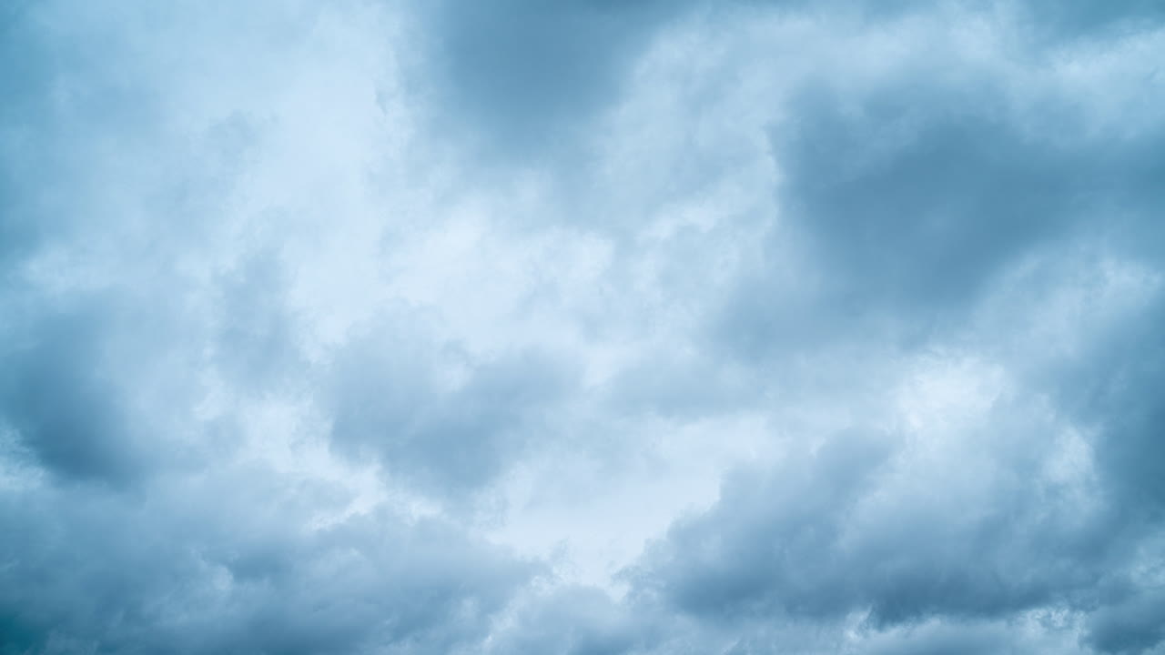 Timelapse of fast movement of dark rain clouds. Blue fluffy clouds on a gloomy summer day