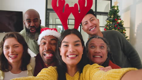 diverse family celebrating christmas, taking selfie with festive hats and smiles
