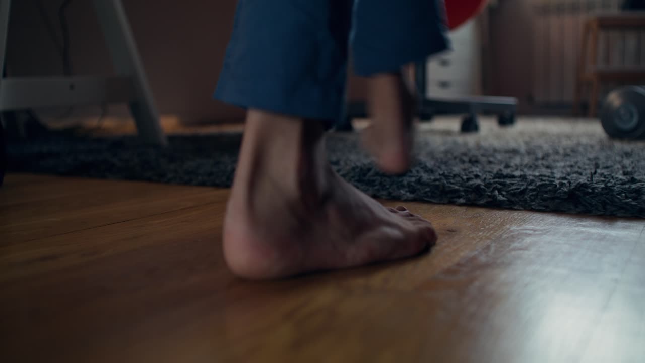 Person getting up from a chair in a room