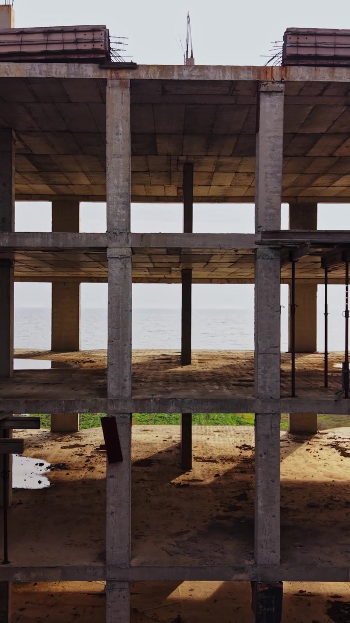 Exploring an abandoned structure by the seaside at sunset