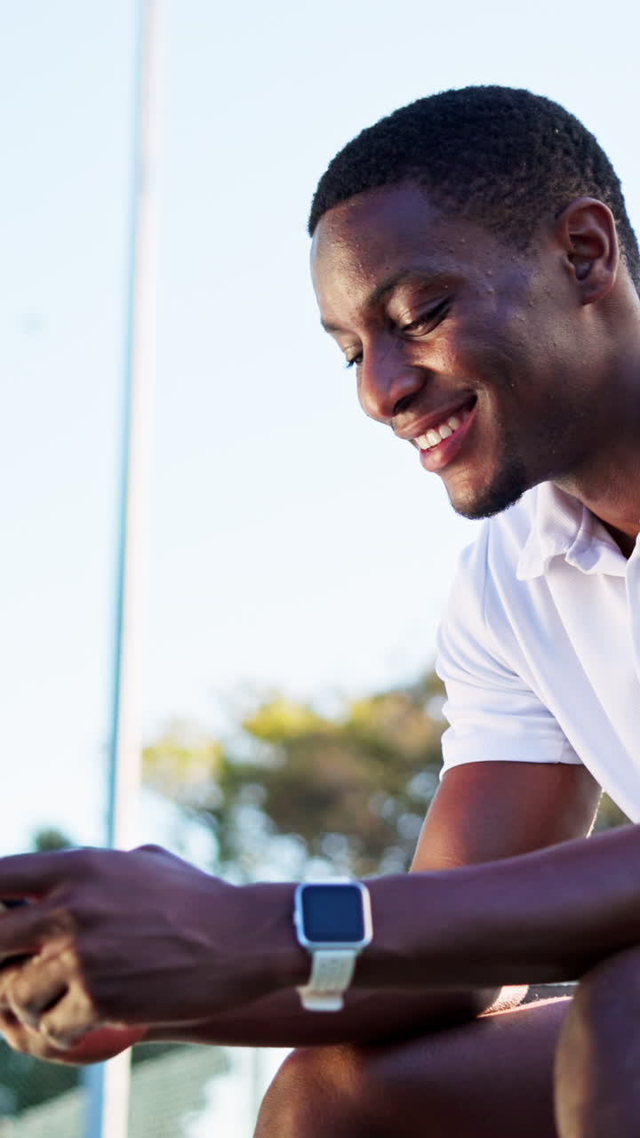 Young Black Man Smiling and Using Smartwatch Outdoors