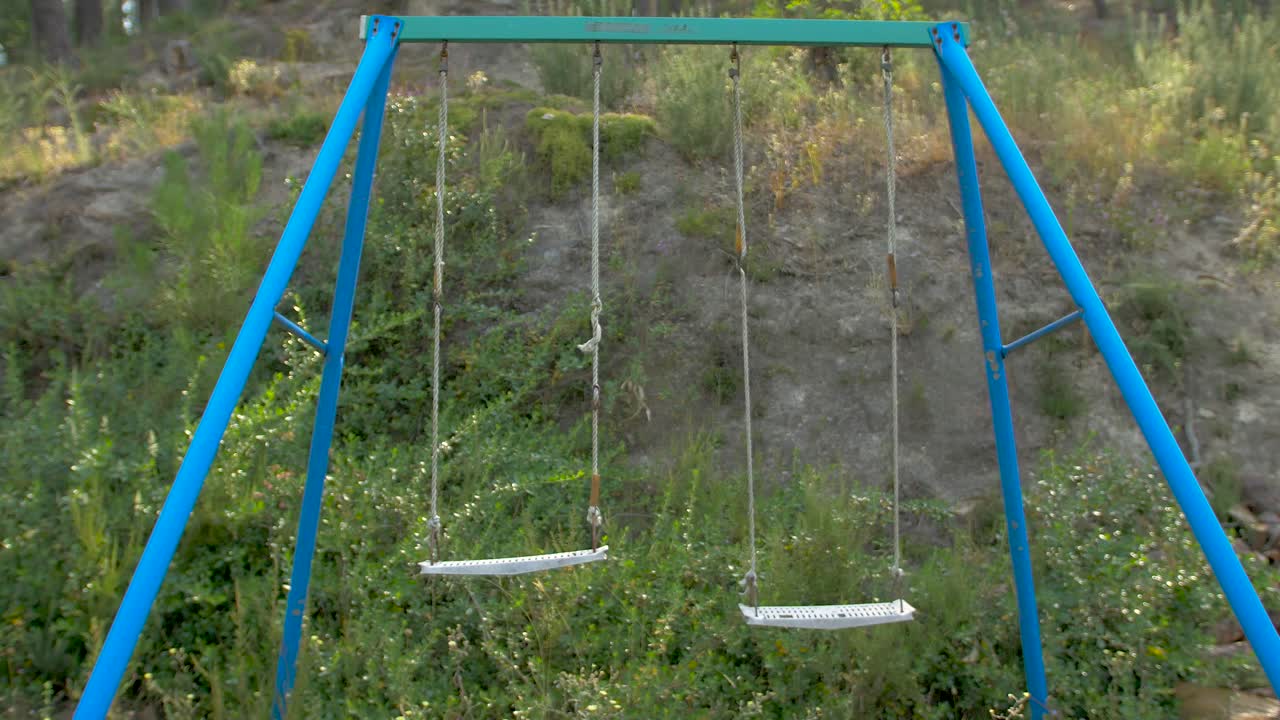 Abandoned swing in a wild camp