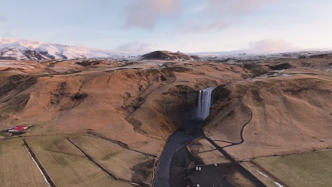 aerial - Skógafoss waterfall and snowy highlands near Eyjafjallajökull Iceland