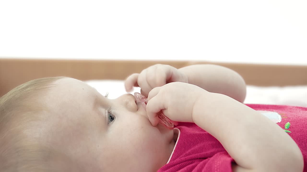 Mom gives baby a pacifier