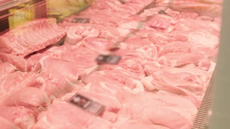 a meat shop specializing in fresh products. the scene shows neatly arranged meat on display counters, showcasing high-quality cuts in a clean and professional retail environment