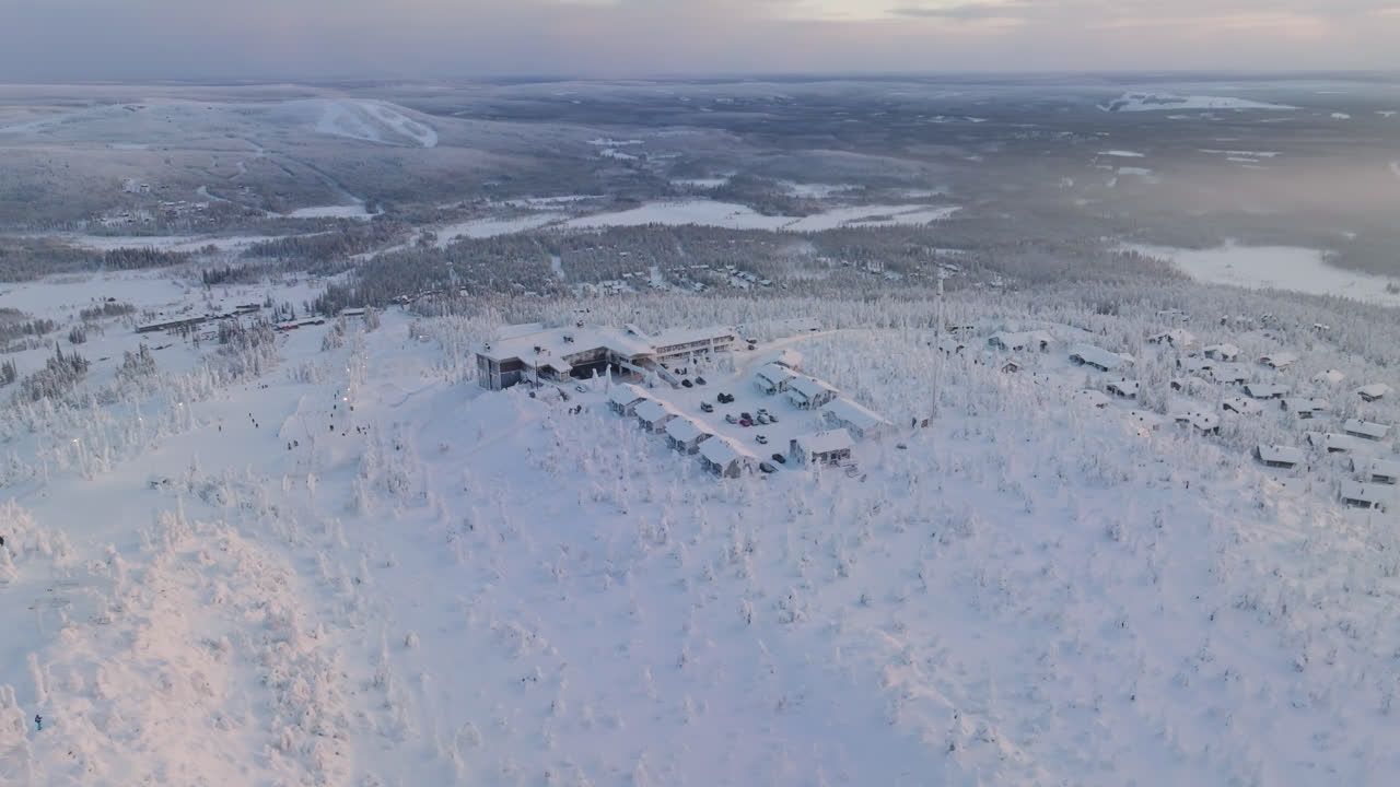 Aerial view overlooking the top of the Iso-Syote fell, winter sunrise in Finland